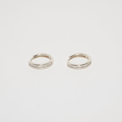 Pair of silver hoop earrings on a light gray background
