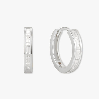 Silver hoop earrings with embedded stones on a white background