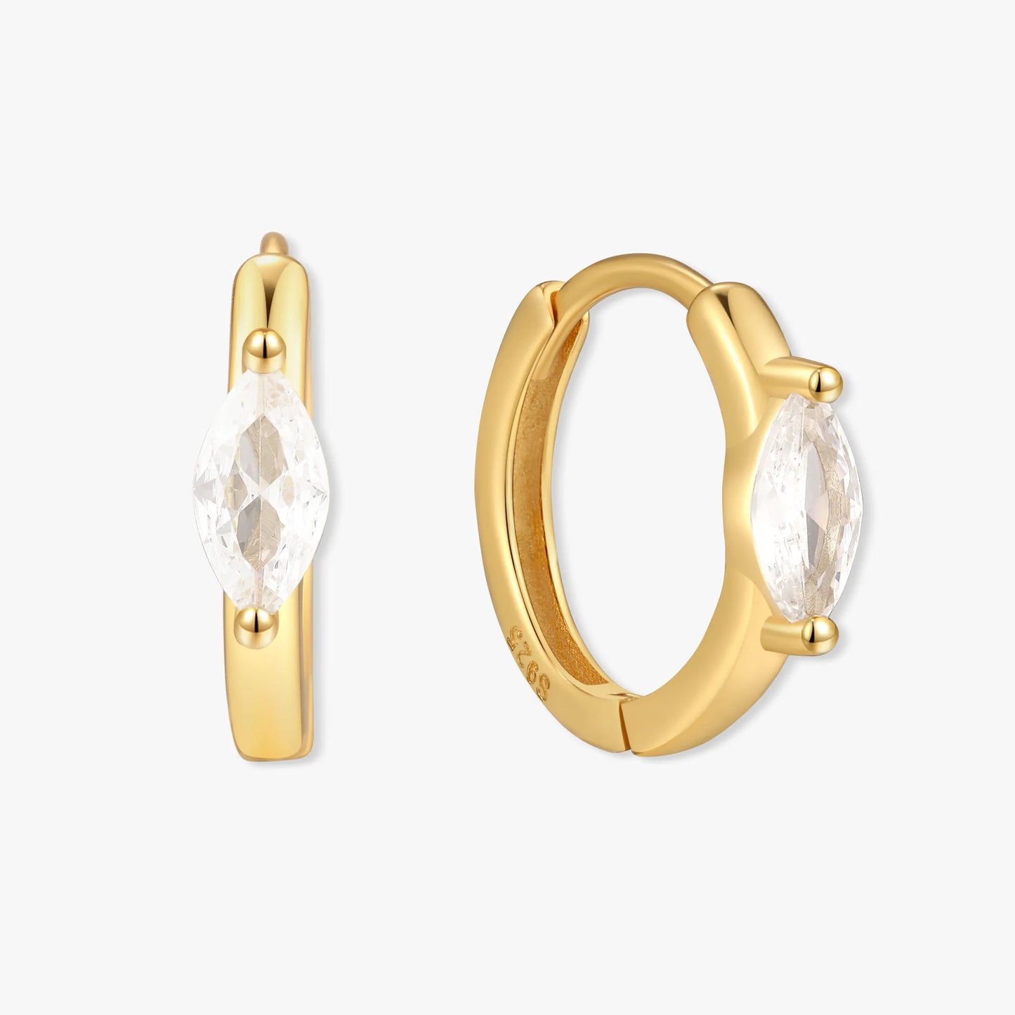 Gold hoop earrings with clear gemstones on a white background