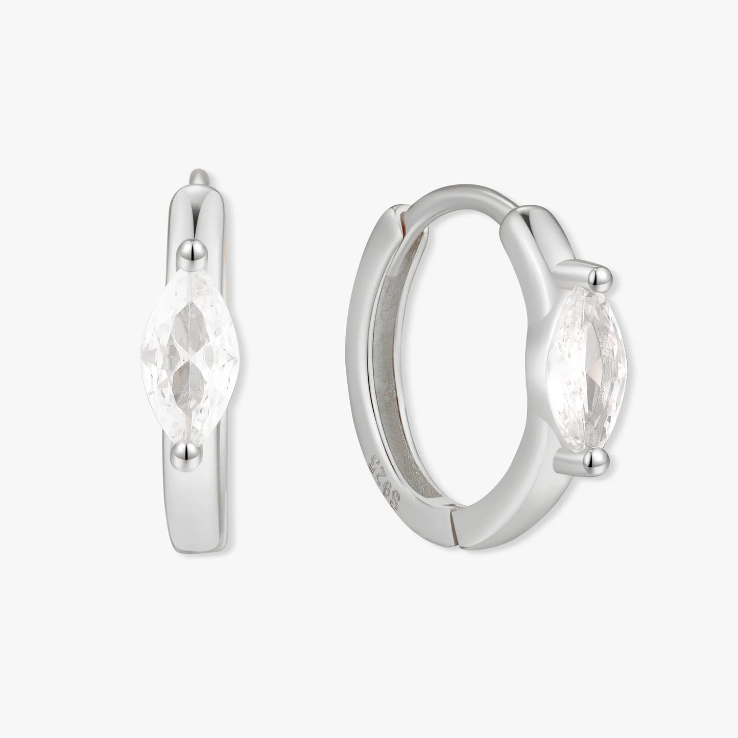 Silver hoop earrings with clear gemstones on a white background