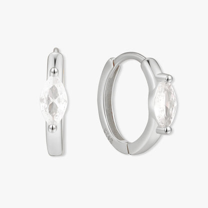 Silver hoop earrings with clear gemstones on a white background