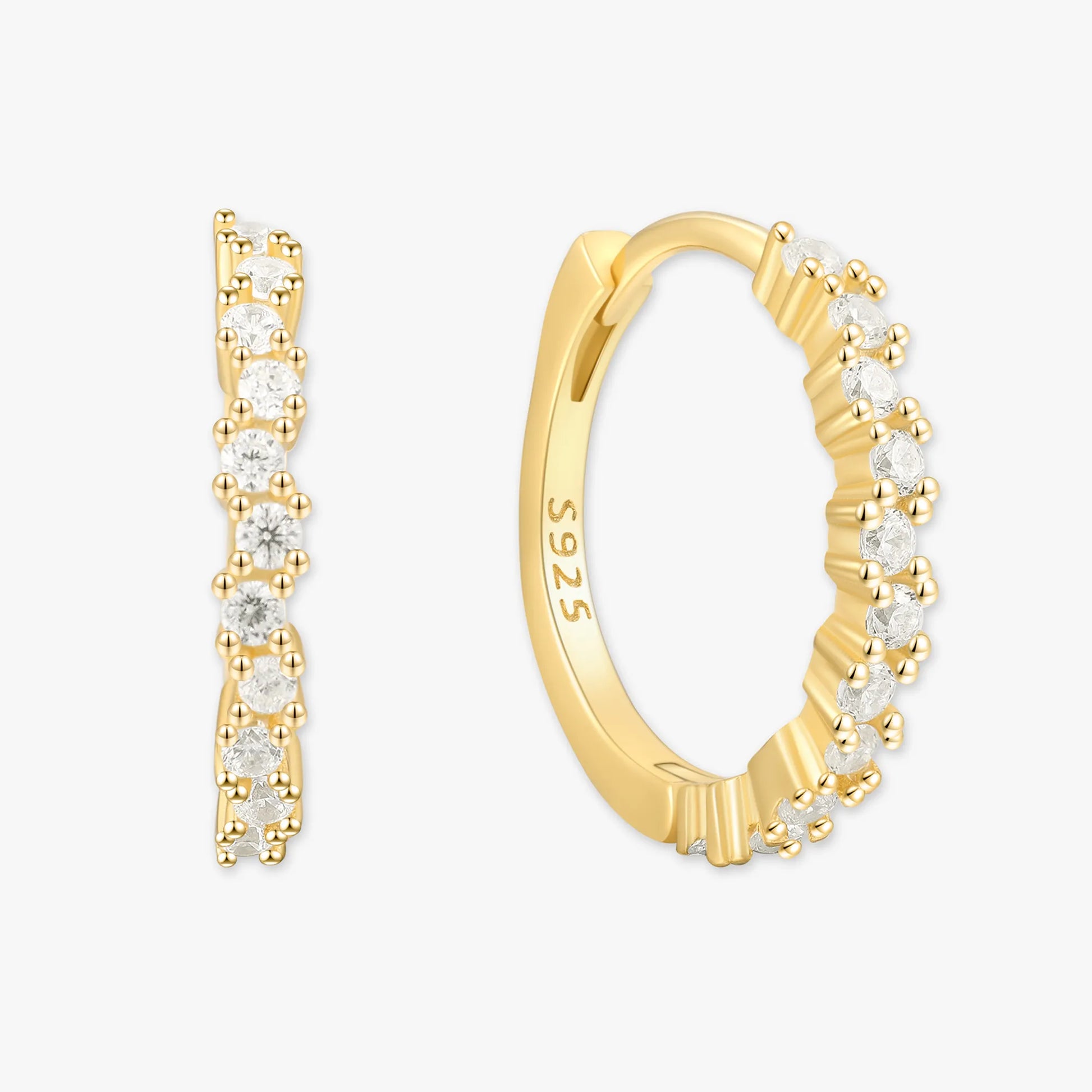 Gold hoop earrings with embedded diamonds on a white background