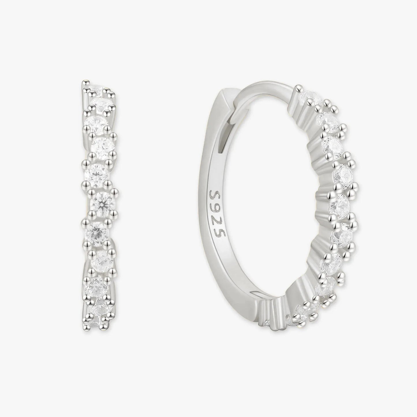 Silver hoop earrings with clear gemstones on a white background