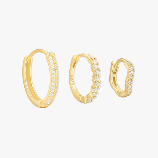 Gold hoop earrings with embedded stones on a white background