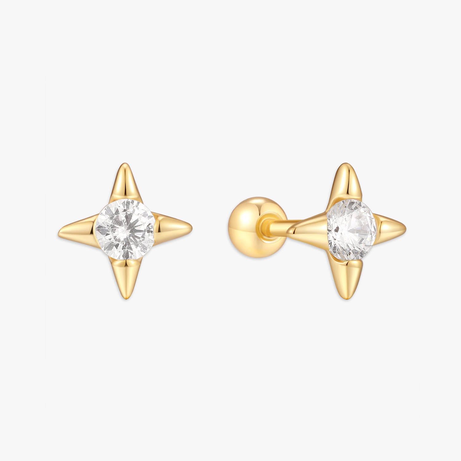 Gold spike earrings with clear gemstones on a white background