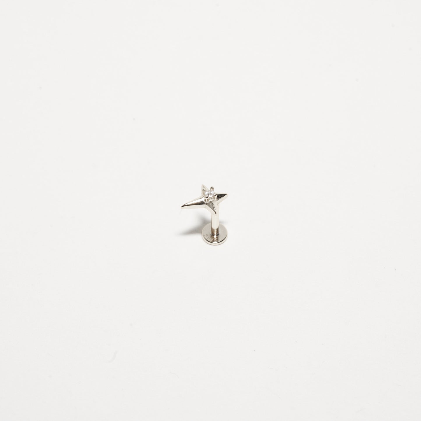 Small silver angel figurine on a white background