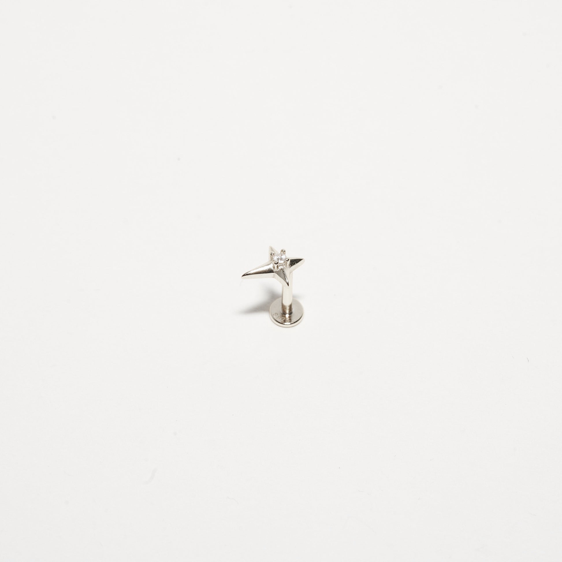 Small silver angel figurine on a white background