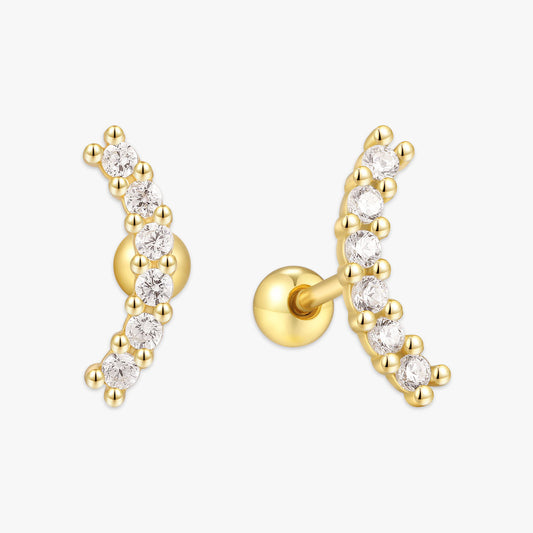 Gold earring with clear gemstones on a white background