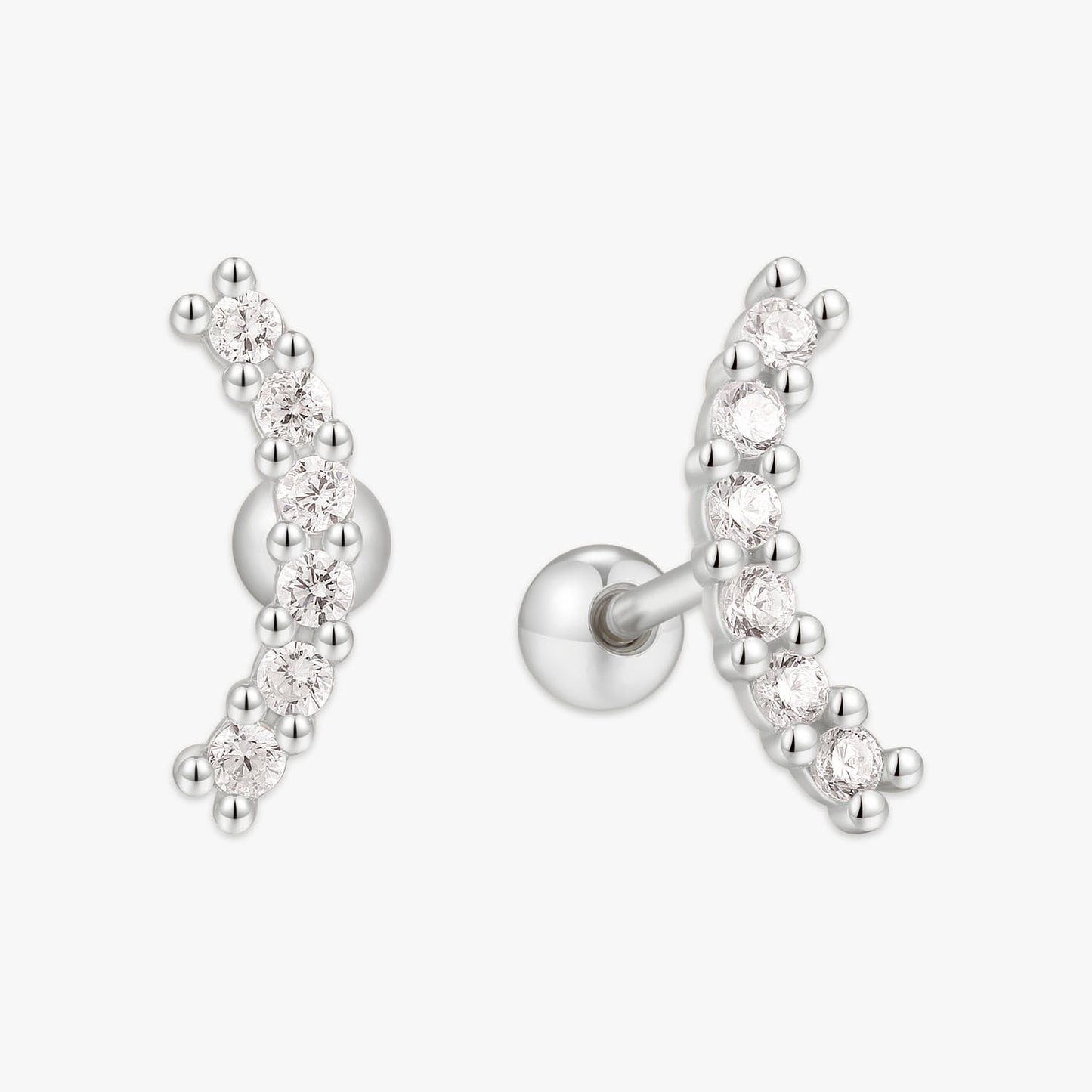 Silver earrings with clear gemstones on a white background