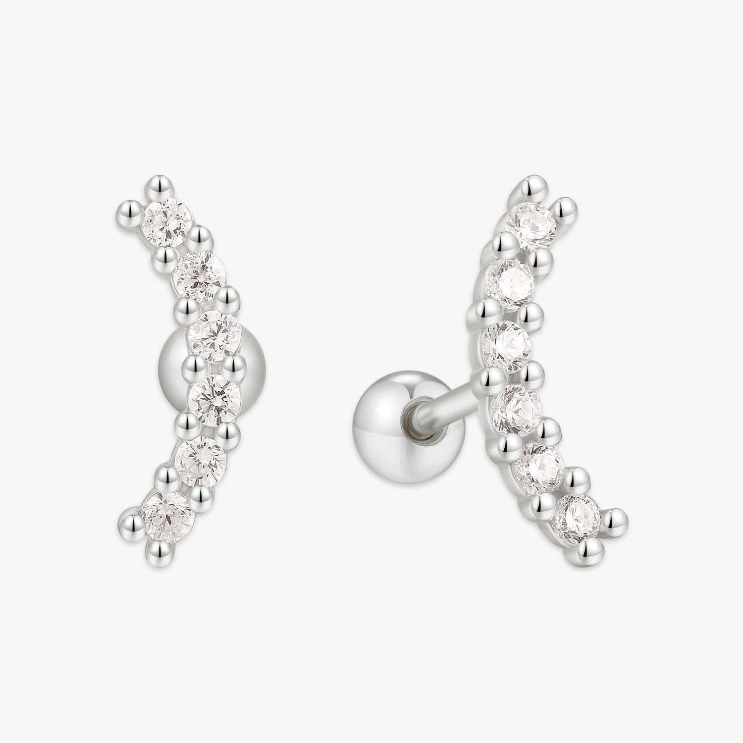 Silver earrings with clear gemstones on a white background