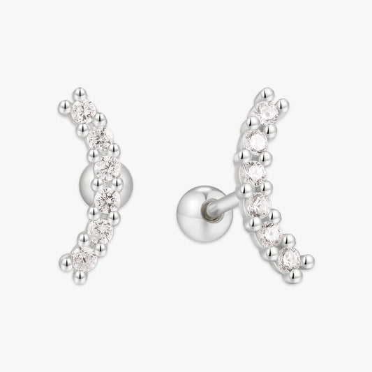 Silver earrings with clear gemstones on a white background
