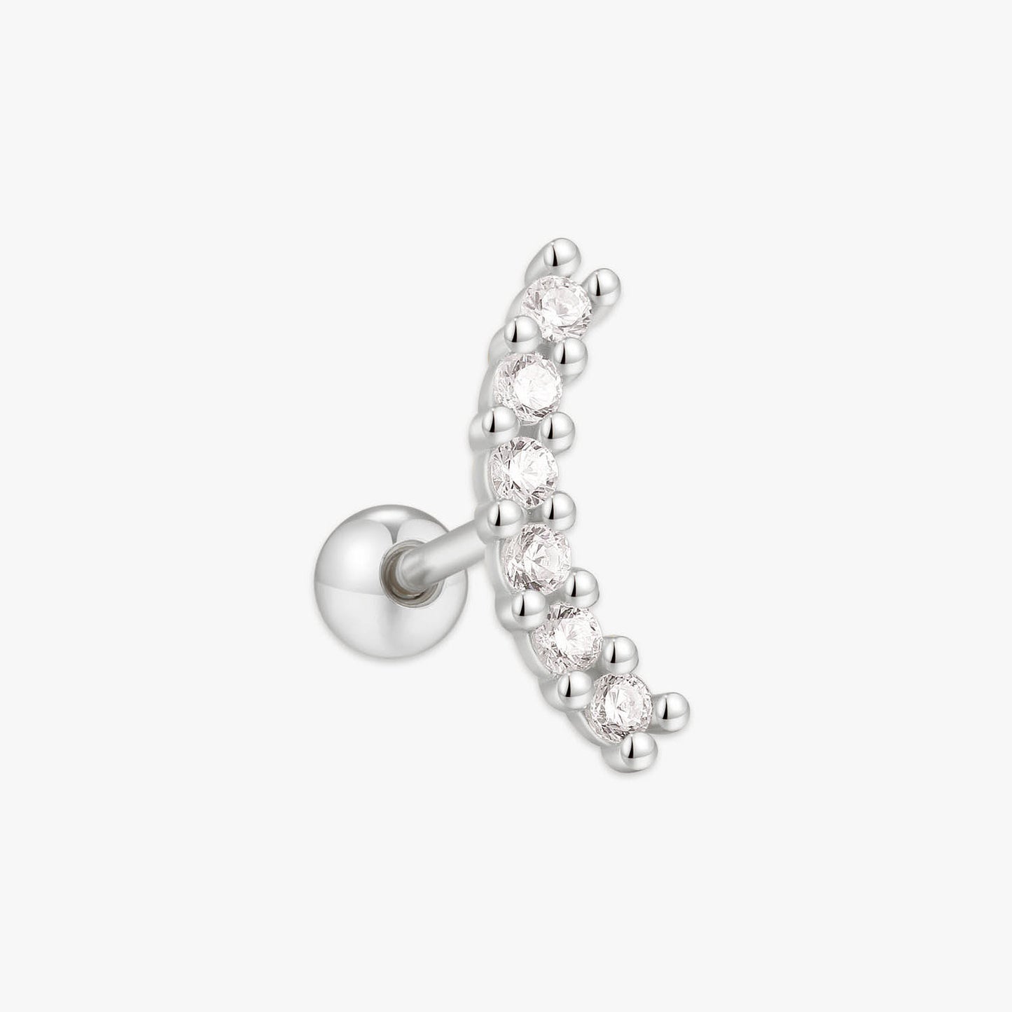 Silver earring with clear gemstones on a white background