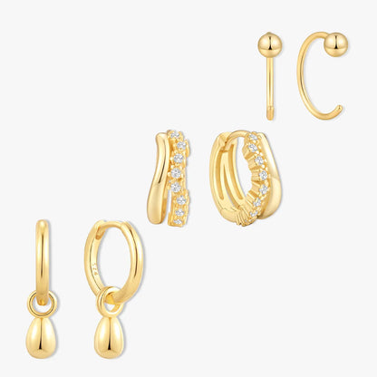 Set of gold earrings on a white background