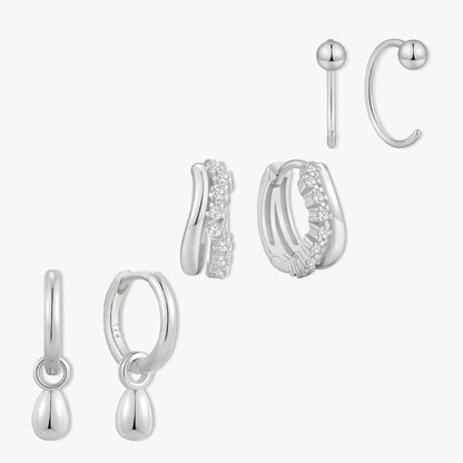 Set of silver earrings on a white background