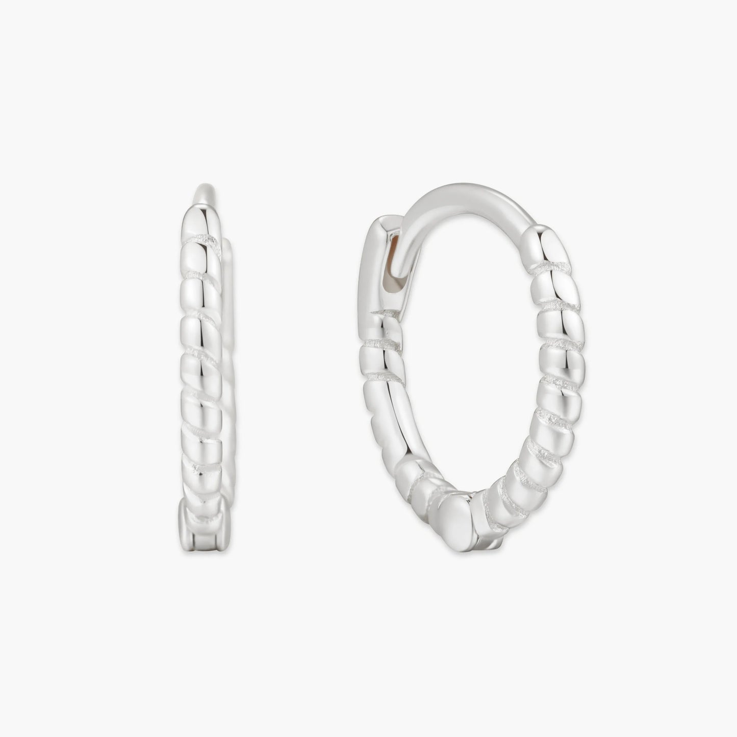 Pair of silver hoop earrings on a white background