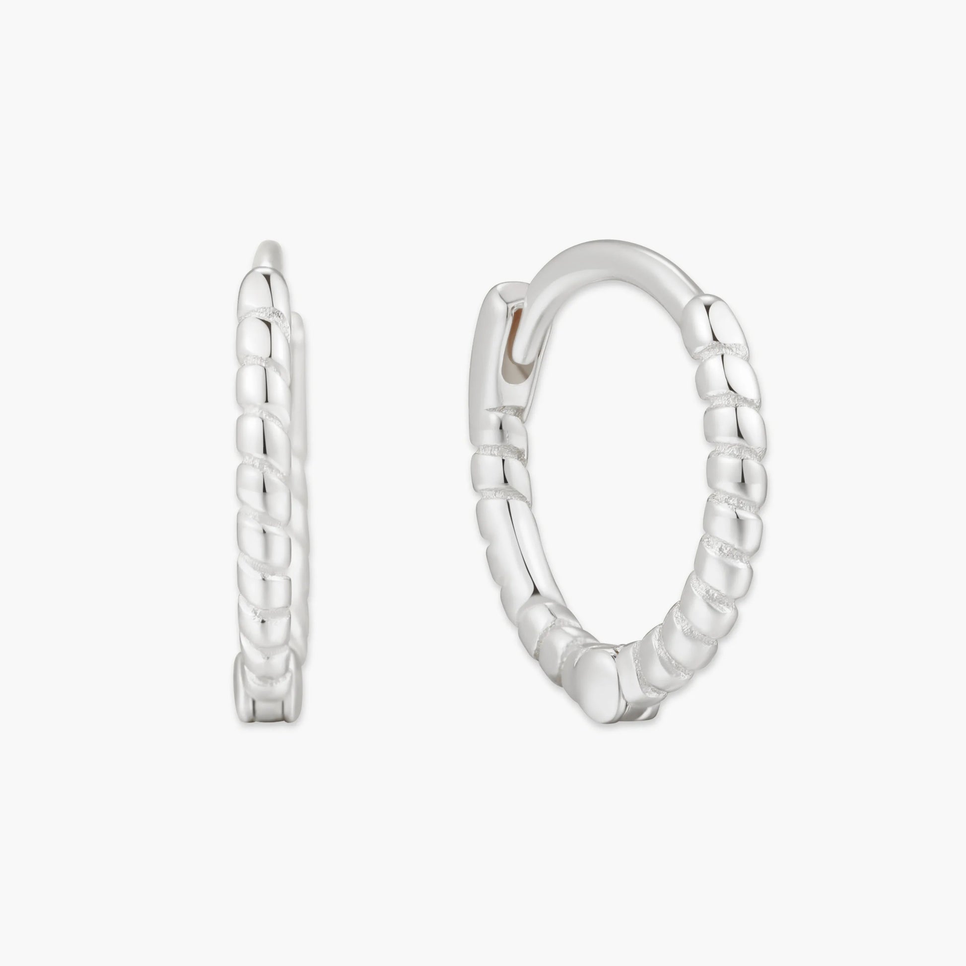 Pair of silver hoop earrings on a white background
