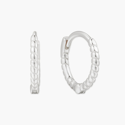 Pair of silver hoop earrings on a white background