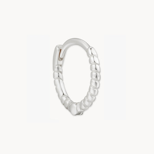 Silver hoop earring on a white background