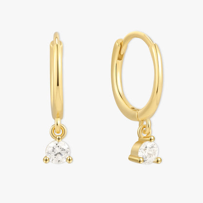 Gold hoop earrings with small round gemstones on a white background