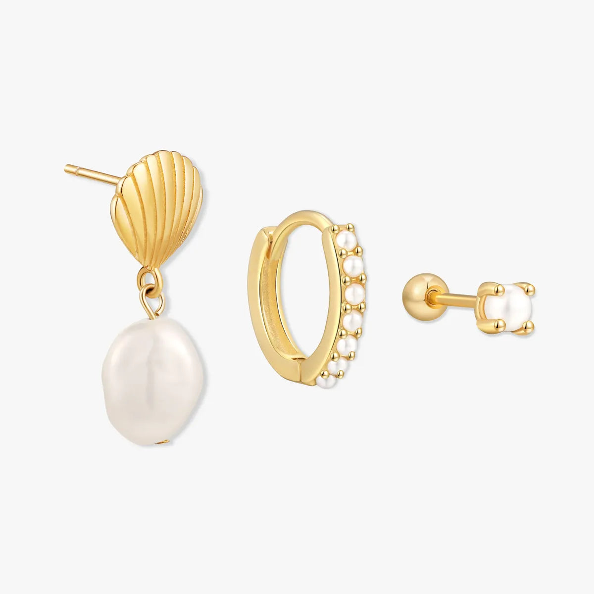 Set of gold earrings with pearls on a white background