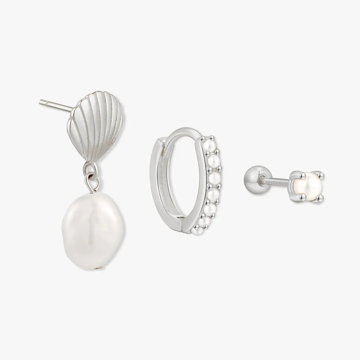 Set of silver earrings on a white background