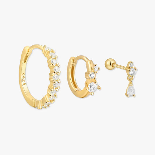 Gold hoop earrings with small diamonds on a white background