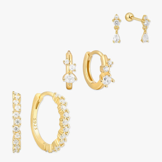 Gold hoop earrings with clear gemstones on a white background