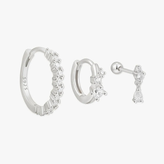 Set of silver hoop earrings and a stud earring on a white background