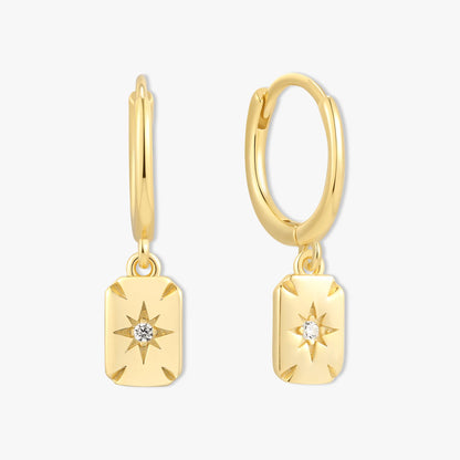 Gold hoop earrings with star-shaped pendants on a white background