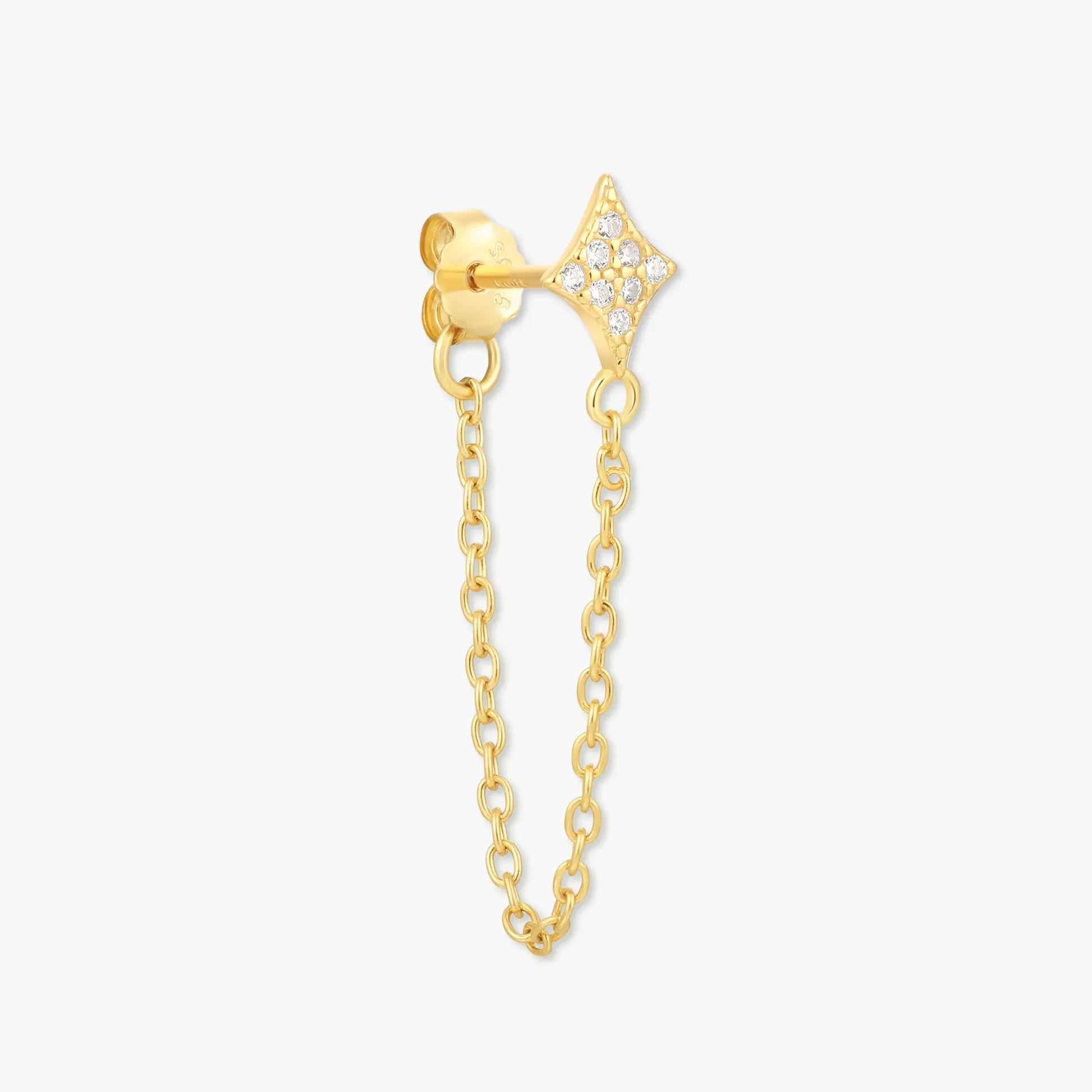 Gold earring with chain on a white background