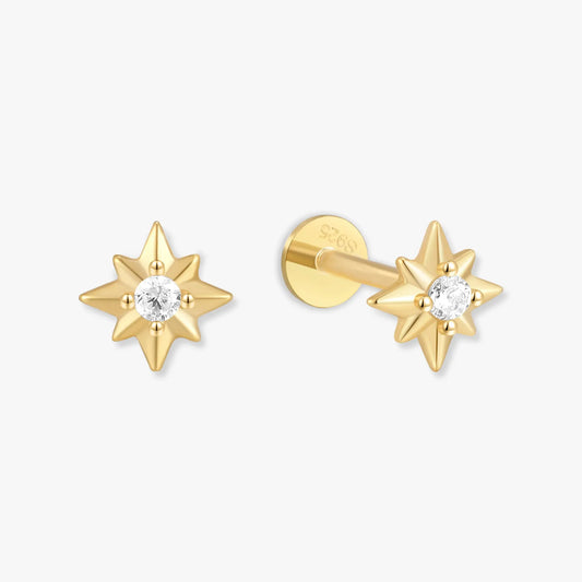 Gold star-shaped earrings with clear gemstones on a white background
