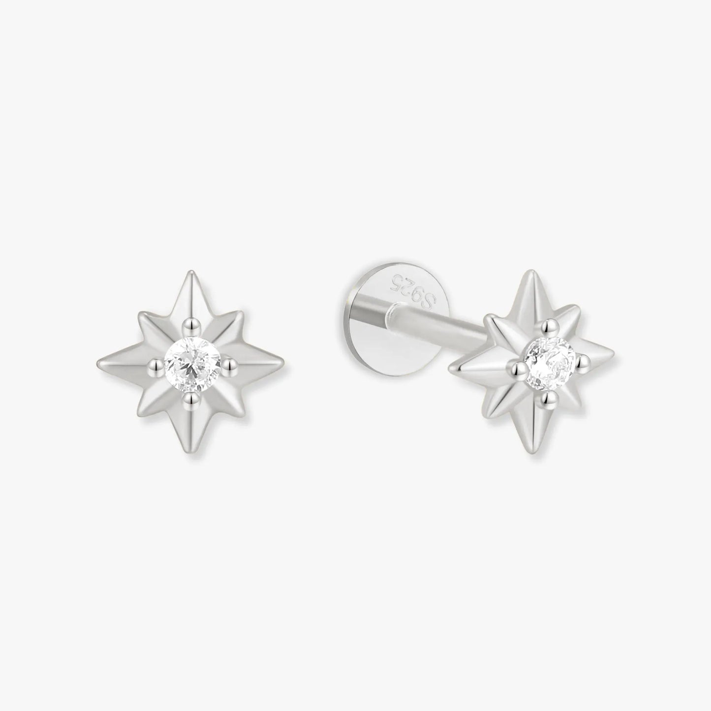 Star-shaped silver earrings with clear gemstones on a white background