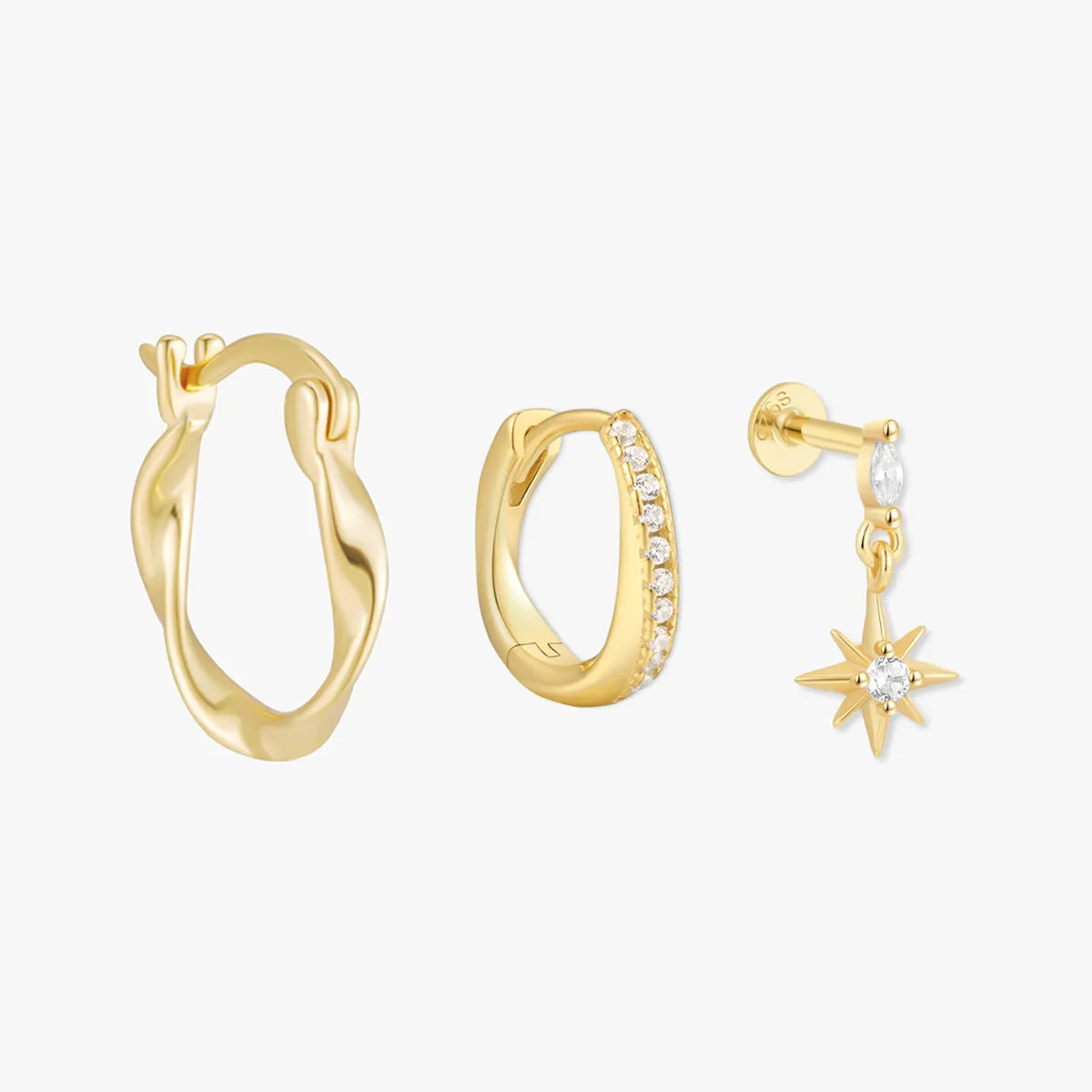 Three gold hoop earrings on a white background