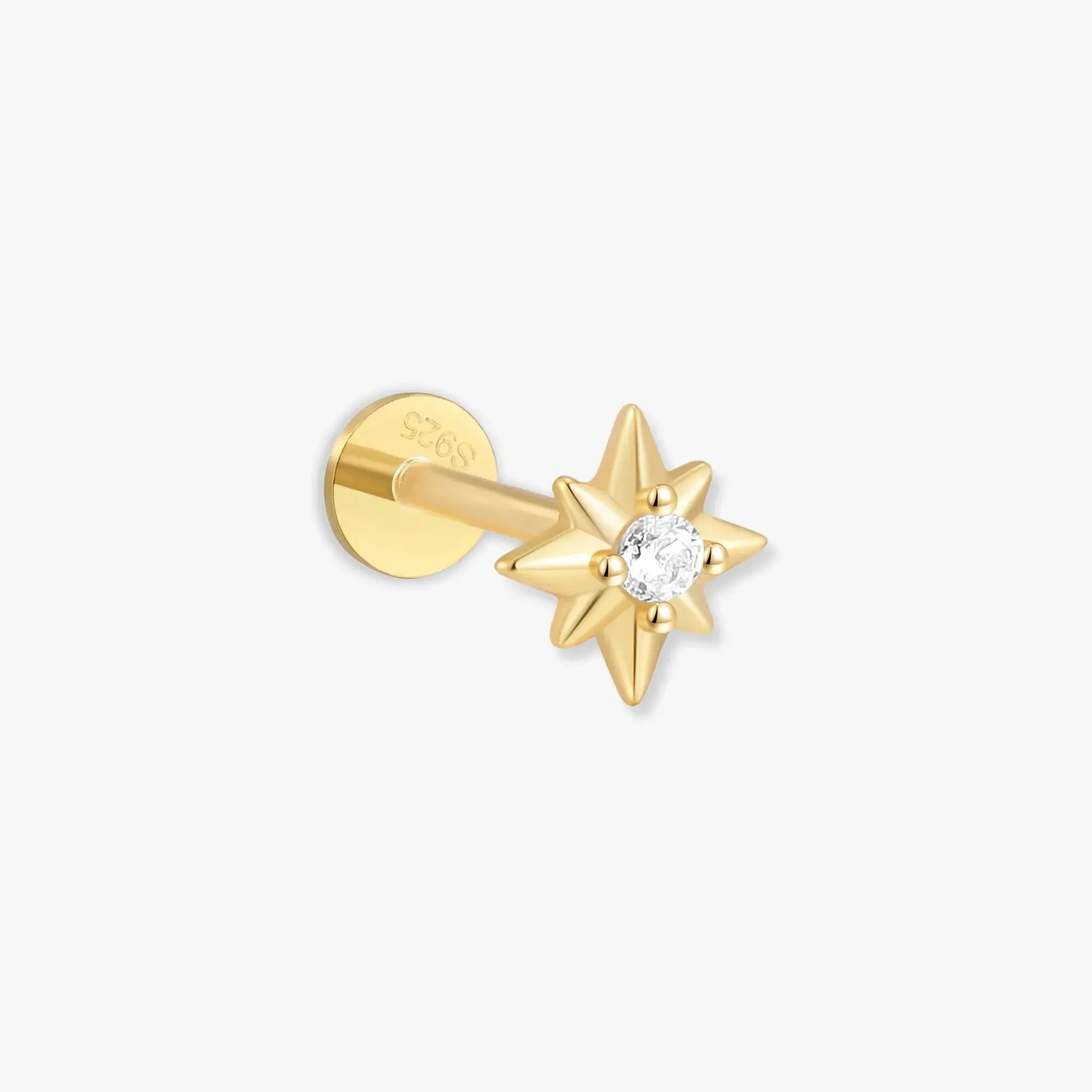 Gold star-shaped earring with a clear gemstone on a white background