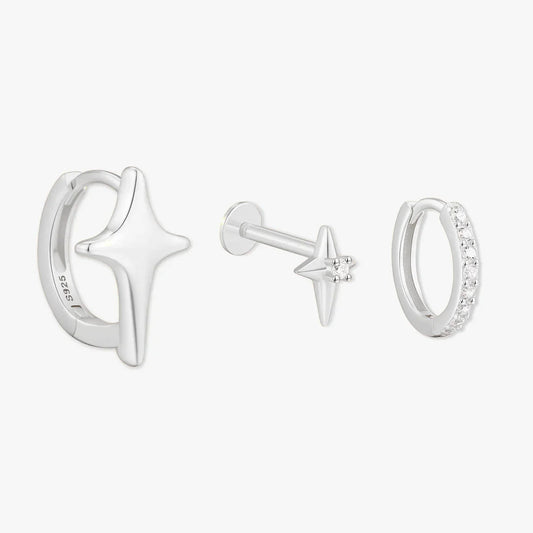 Set of silver earrings with star designs on a white background