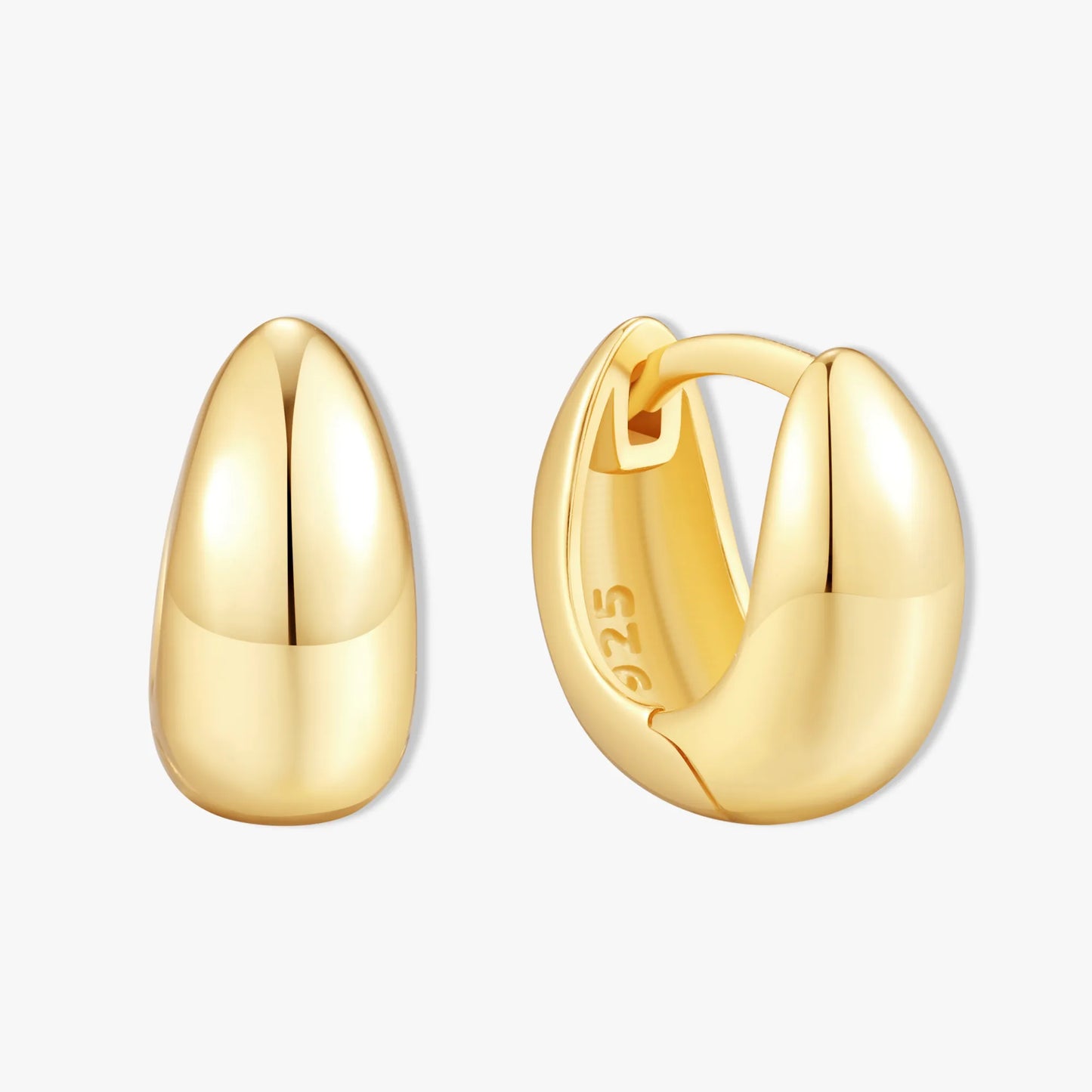 Gold hoop earrings on a light gray background