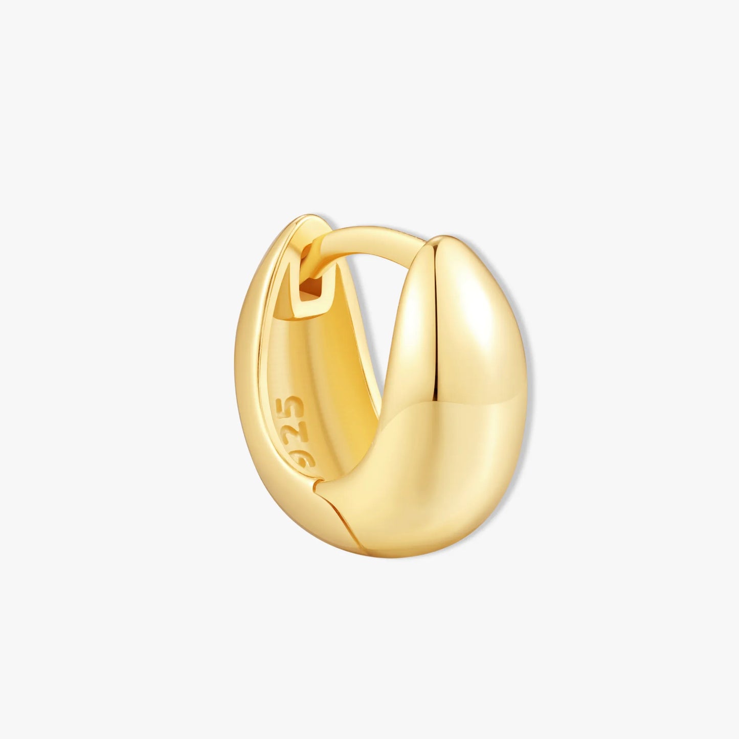 Gold hoop earring on a white background