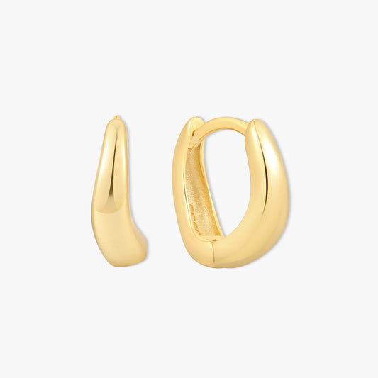 Gold hoop earrings on a light gray background