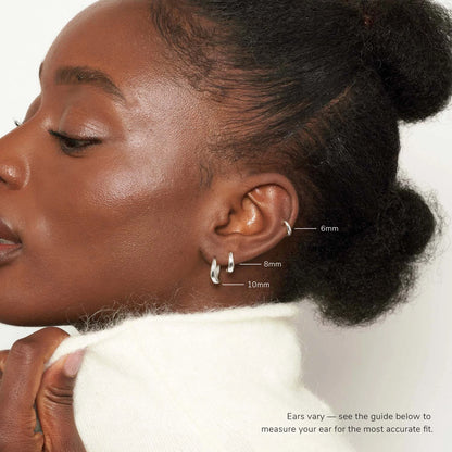 Close-up of a woman's ear with earrings, showing size measurements.