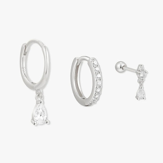 Set of silver hoop earrings with a teardrop pendant on a white background