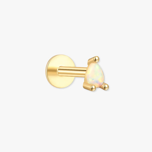 Gold earring with a white gemstone on a white background