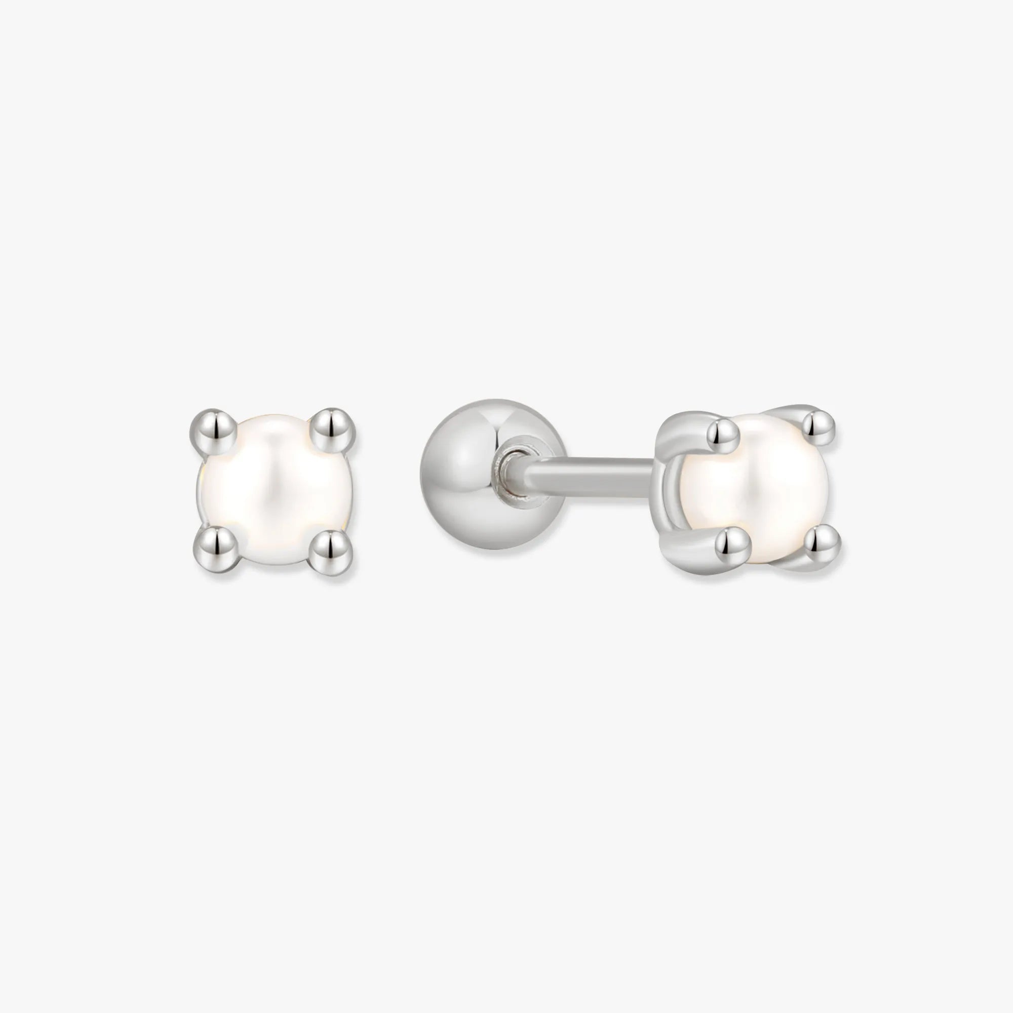 Pair of pearl stud earrings with silver posts on a white background