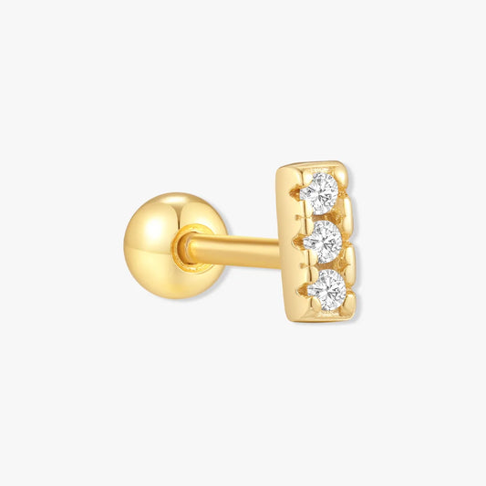 Gold earring with three diamonds on a white background