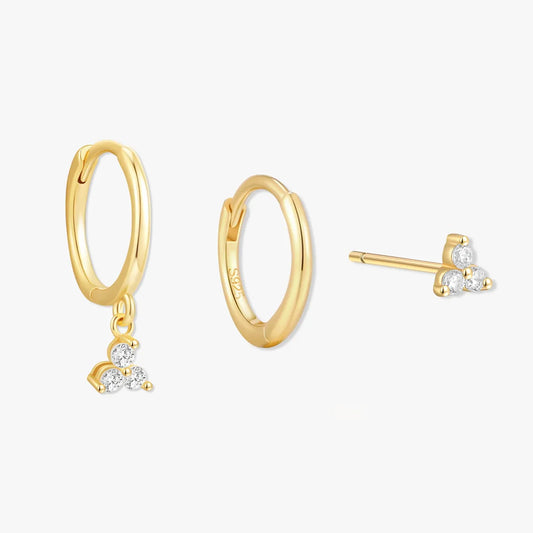 Gold hoop earrings with heart-shaped diamond charms on a white background