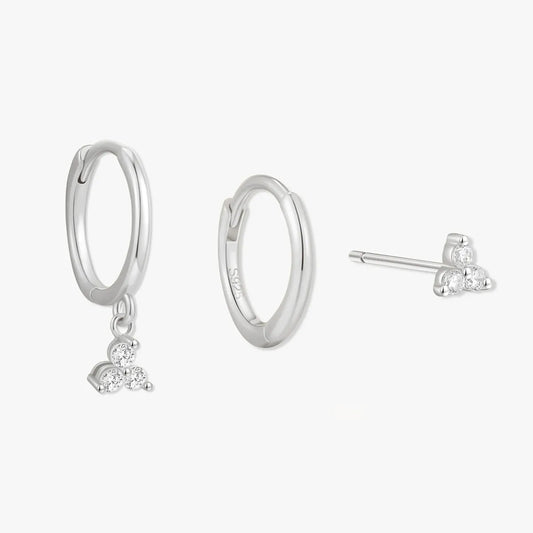 Silver hoop earrings with heart charms on a white background