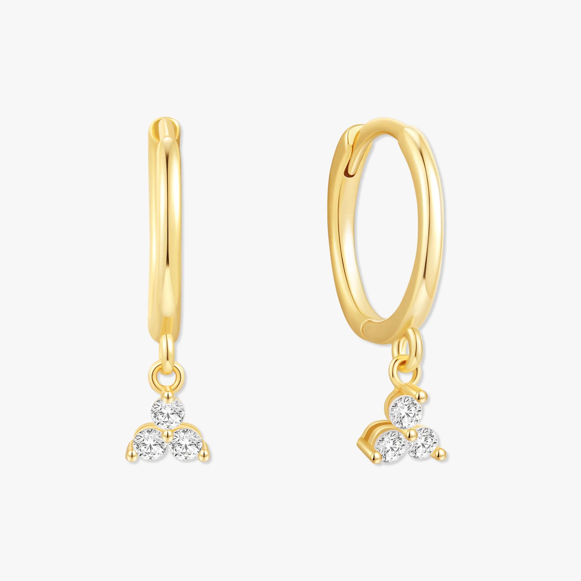 Gold hoop earrings with diamond pendants on a white background