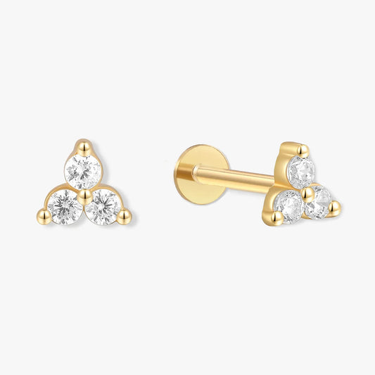 Gold earrings with clear gemstones on a white background