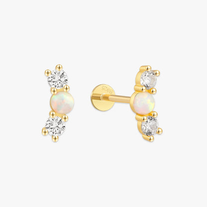Pair of gold earrings with opal and diamond stones on a white background