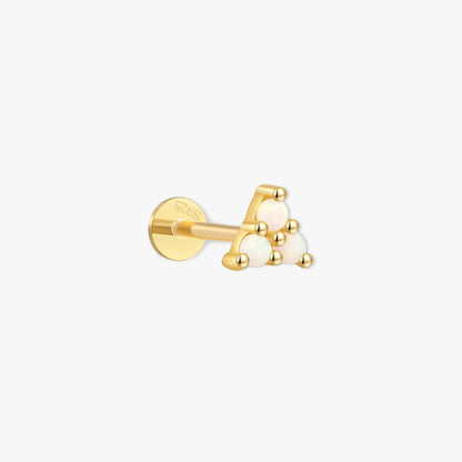 Gold earring with three white gemstones on a white background