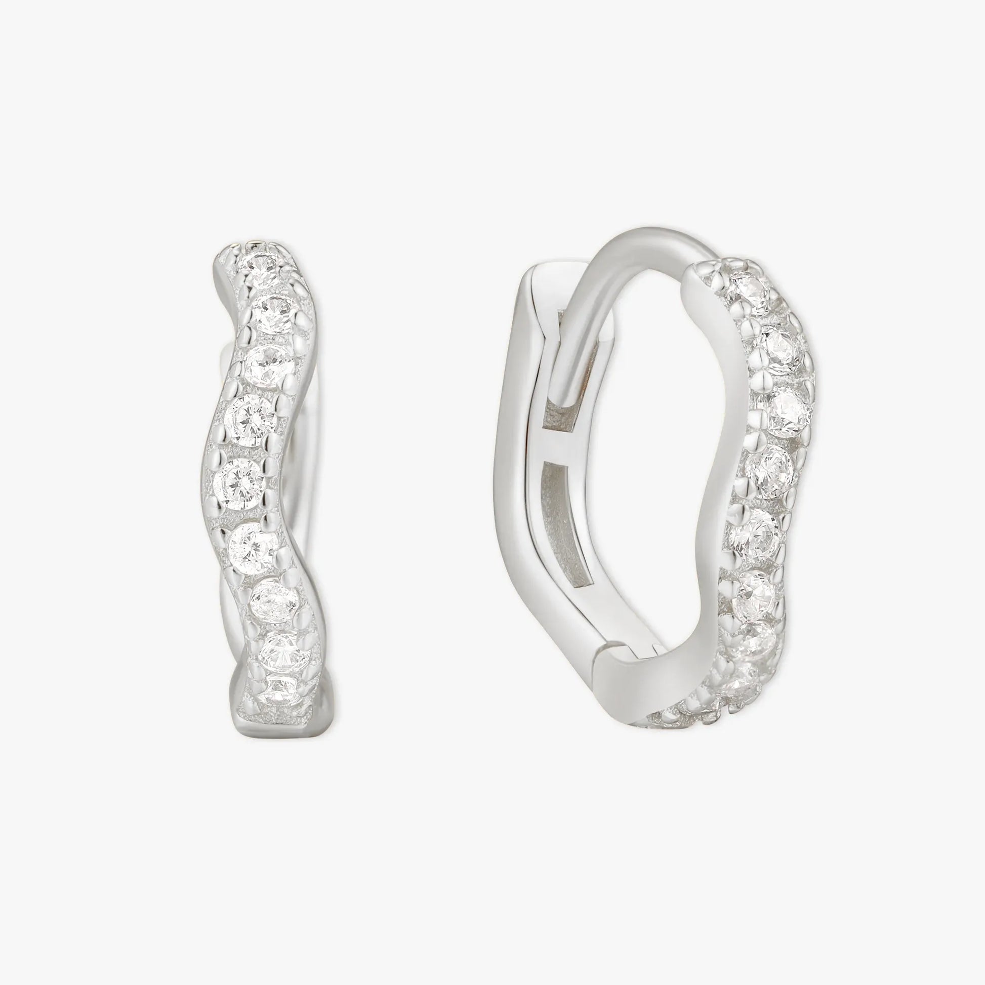 Silver hoop earrings with embedded stones on a white background